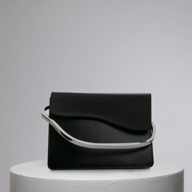 Aiges, which means "Waves" in Greek, is an elegant and contemporary piece celebrated by one and only single compartment. Aiges’s oversized biomorphic and sculptured circular metal handle add a more polished and assertive touch to this minimal design. 

DETAILS

24cm (H) x 18,5cm (W) x 7cm (D),
Calf Leather Magnetic closures Metal handle
Long crossbody strap
An accordion-like compartments
Embossed NATURAE SACRA lettering at front
One interior pouch pocket
Dust bag and branded box included 


 
 





PRODUCT CARE



CALF LEATHER:   Each leather hides unique characteristics such as texture and natural markings. Also, the most prominent feature of vegetal tanned leather is that it changes color with usage. Aging and tone variations should not be considered an imperfection as leather is a natural product. Please, avoid contact with water and any oil-based substances. 
METAL HANDLES:  Metal handles are handmade and each piece has a its uniqueness points, which means that there are not two alike pieces.   





 
Fulfilled by our friends at NATURAE SACRA 
*Please Note: 

 Rewards cannot be applied to this product
This item is not eligible for returns 
This item cannot be shipped outside the U.S.

 


 
