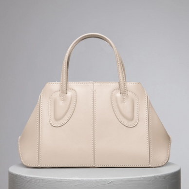 Ev stands for home, something we treasure as a family and team. Now this family has a midi version of it! This non-structured tote was thought to be one of our strongest styles by bringing absolute function and practicality to a new distinctive level as size goes within our collections. Ev Midi's soft leather allows women to be versatile and dynamic thanks to its shapeless capability. Ev is certainly that elevated. Twist it, and fold it with the magnets at the sides, it is a perfect daily bag with a short leather handle or it can become a shoulder bag with a removable cross-body strap. 
 

DETAILS

25 cm (H) x 23 cm (W) x 8 cm (D)
%100 Calf Leather 
%100 calf suede interior
Hand carry, shoulder carry and crossbody carry
Embossed NATURAE SACRA lettering at front 
Dust bag included 





 
PRODUCT CARE



CALF LEATHER:   Each leather hides unique characteristics such as texture and natural markings. Also, the most prominent feature of vegetal tanned leather is that it changes color with usage. Aging and tone variations should not be considered an imperfection as leather is a natural product. Please, avoid contact with water and any oil-based substances. 
  





Fulfilled by our friends at NATURAE SACRA 
*Please Note: 

 Rewards cannot be applied to this product
This item is not eligible for returns 
This item cannot be shipped outside the U.S.



 
  