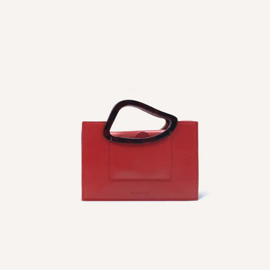 The mini bag version of Arp’s Sailent is combines vintage elegance, modernity and sophistication with a minimal clean cut. It's organic shaped resin handles are indicative of Naturae Sacra’s signature design detailing. This un-conventional handles design has been crafted to allow ergonomic gripping. Design process of Arp’s Sailent took an inspration by Hans (jean) Arp’s ‘silence’ named abstract sculpture which is most simple but most compelling. 

DETAILS


 13cm (H) x 19cm (W) x 5cm (D),
Calf Leather Magnetic closures Natural resin casting handle
Long cross-body strap Two accordion-like compartments
Embossed NATURAE SACRA lettering at the front
Two interior pouch pocket
A card holding slit at the back Dust bag and branded box included 


 




PRODUCT CARE
CALF LEATHER:   Each leather hides unique characteristics such as texture and natural markings. Also, the most prominent feature of vegetal tanned leather is that it changes color with usage. Aging and tone variations should not be considered an imperfection as leather is a natural product. Please, avoid contact with water and any oil-based substances. 
RESIN HANDLES:  Resin handles are handmade and each piece has a its uniqueness points, which means that there are not two alike pieces. For that reason, we cannot guarantee you will receive an item exactly identical to what is pictured. Colors and swirls shown are a guideline only.  Resin is strong and durable and should be treated like a ceramic since it can break if dropped or knocked against a hard surface. Also, it does not show resistance to very high temperatures.  
 
Fulfilled by our friends at NATURAE SACRA 
*Please Note: 

 Rewards cannot be applied to this product
This item is not eligible for returns 
This item cannot be shipped outside the U.S.


 




 
