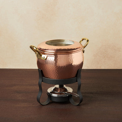Fondue is the perfect communal activity for a big family weekend dinner or for a fun party with friends. 
You can use our 4-piece Fondue Michelle to make oil-based or broth-based fondues at the table in European style, but also for a Chinese hot pot or a Japanese-style shabu-shabu. The copper collar prevents splatters, while the chromed burner allows adjustment of the flame. The beautifully hand-hammered, tin-lined copper pot can also be used as a normal saucepot on your gas stove and in the oven. This set further includes a decorative iron stand and a convenient gel fuel holder. Made in Italy. 
Fulfilled by our friends at Ruffoni US 
*Please Note:Rewards cannot be applied to this productThis item is not eligible for returns 