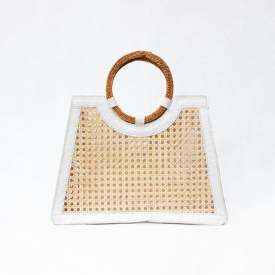 From the beach to shopping and everything in between, Malibu is a hand-held, hand-woven cane bag that'll make the perfect statement to all of your looks. You can use this bag as a nice, large beach tote or even a shopping bag for quick errands! Grab and go and store everything you need while also staying stylish. It's woven cane and leather trim detailing makes this practical bag chic! Dress it up, dress it down and wear it all summer long! The bag also comes with a removable drawstring interior pouch. 
Handmade by artisans in Indonesia 


Handwoven Rattan Leather Bag  



Handcrafted
Rattan; polyester lining
Snap closure
Imported


Dimensions  

11 inches x 14 inches x 4 inches
Handle Drop: 5.5 Inches
1 Interior, No Pocket
Handle Length: 12 Inches
 Fulfilled by our friends at FutureBrandsGroup

Please Note: Rewards cannot be applied to this product


